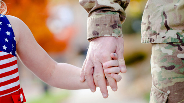 Child With Army Officer (Photo Credit: Thinkstock)