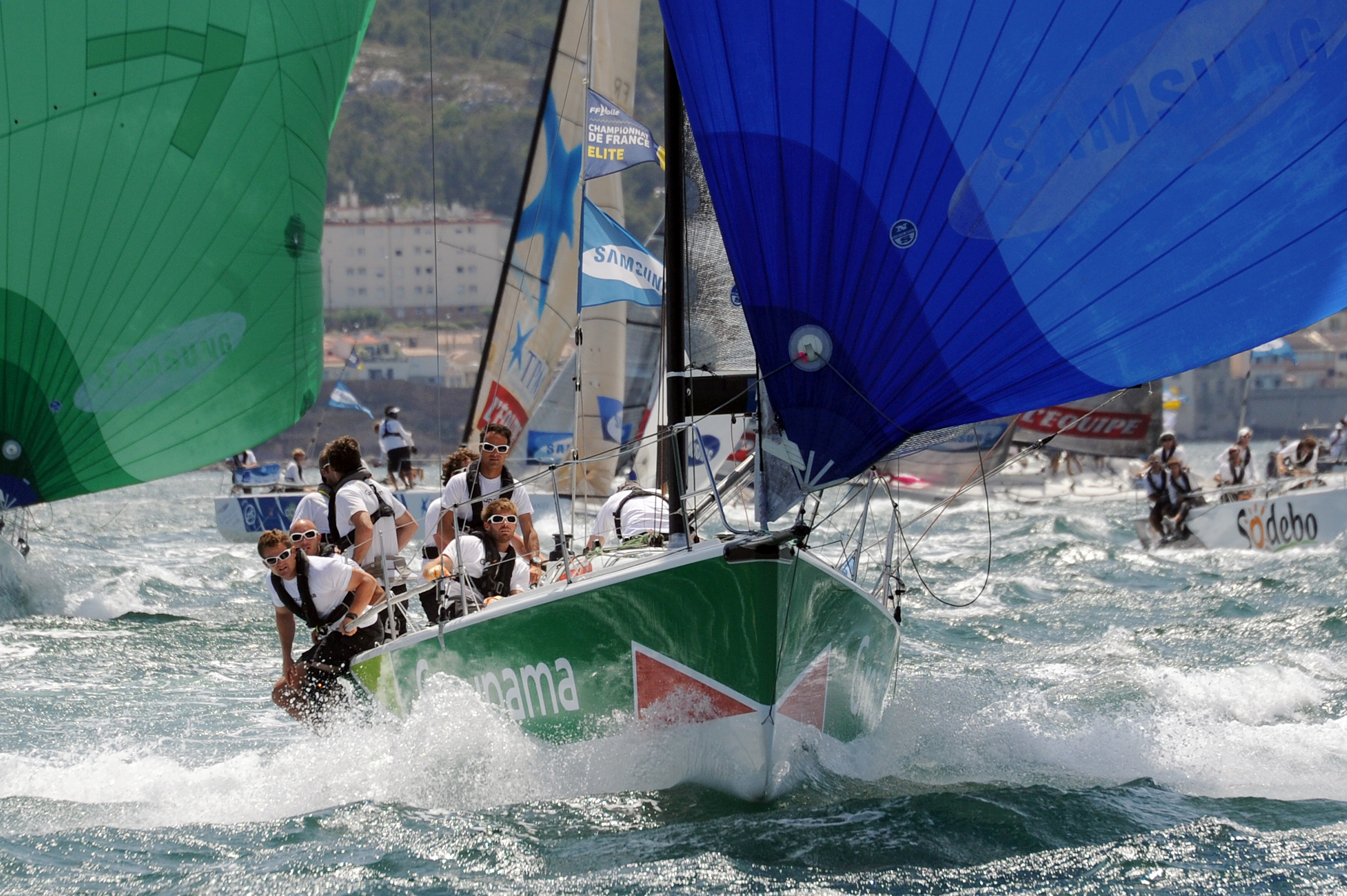 French skipper Franck Cammas (2nd R) and his Groupama 34 crew compete on July 27, 2013 in Marseille, southern France, during the last stage of the Tour de France sailing race between the French southern coastal cities of La Seyne-sur-Mer and Marseille. Cammas and his crew won the overall standings of the competition which left from Dunkerque, northern France, on June 28. (credit: ANNE-CHRISTINE POUJOULAT/AFP/Getty Images)