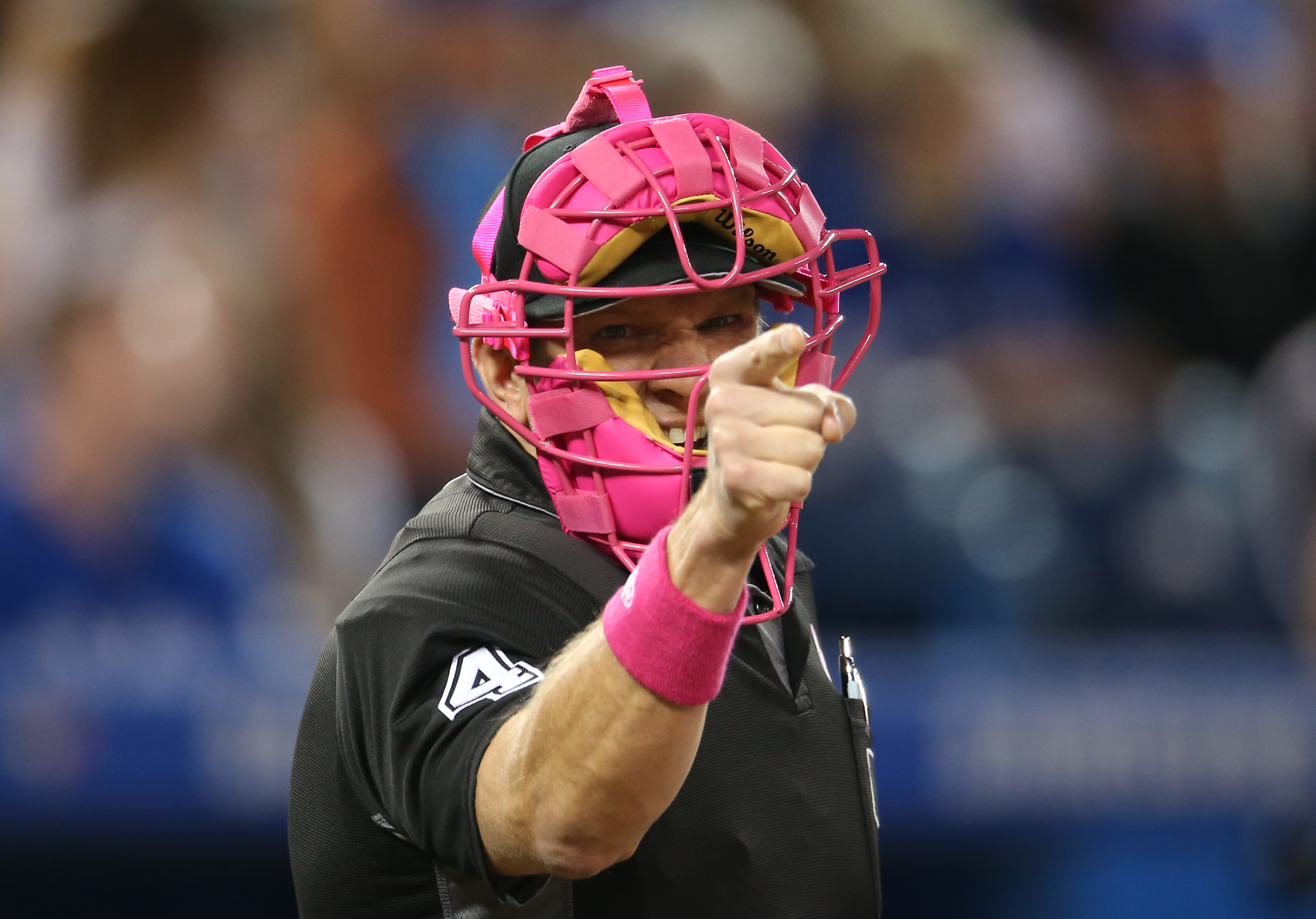 TORONTO, CANADA - MAY 8: Home plate umpire Chad Fairchild #4 calls a strike while wearing a pink mask on Mother's Day during the Toronto Blue Jays MLB game against the Los Angeles Dodgers on May 8, 2016 at Rogers Centre in Toronto, Ontario, Canada. (Photo by Tom Szczerbowski/Getty Images)