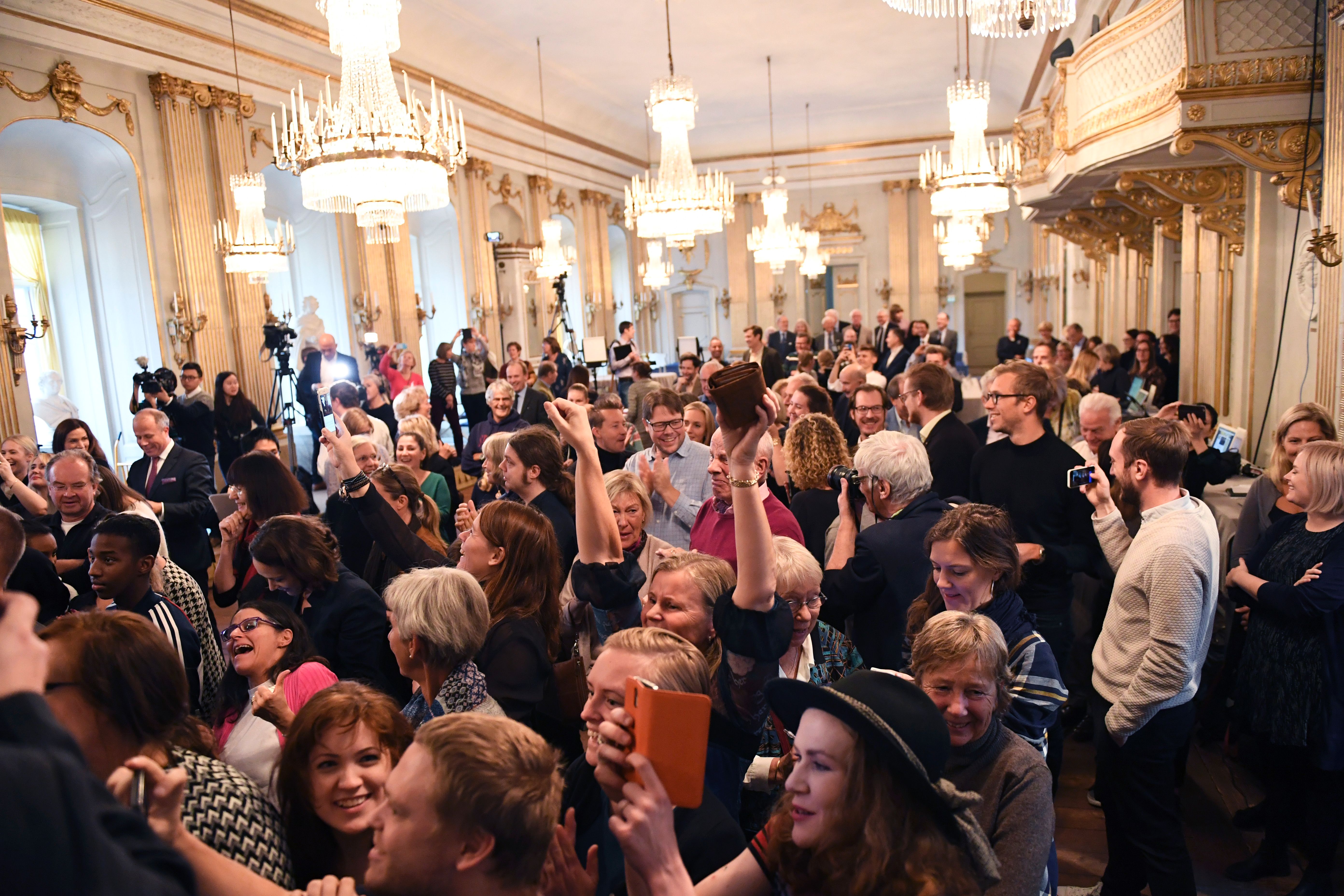The audience reacts as Permanent Secretary of the Swedish Academy Sara Danius announces that Bob Dylan is awarded the 2016 Nobel Prize in Literature during a presser at the Old Stockholm Stock Exchange Building in Stockholm, on October 13, 2016.