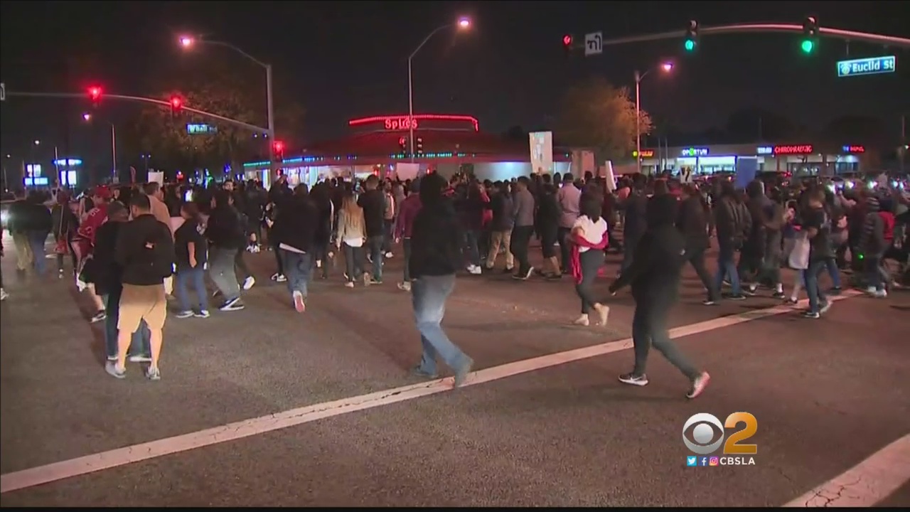 Protesters march through Anaheim, Calif., on Feb. 22, 2017, demanding that authorities arrest an off-duty LAPD officer who fired his gun during a confrontation with some teens on Feb. 21. 