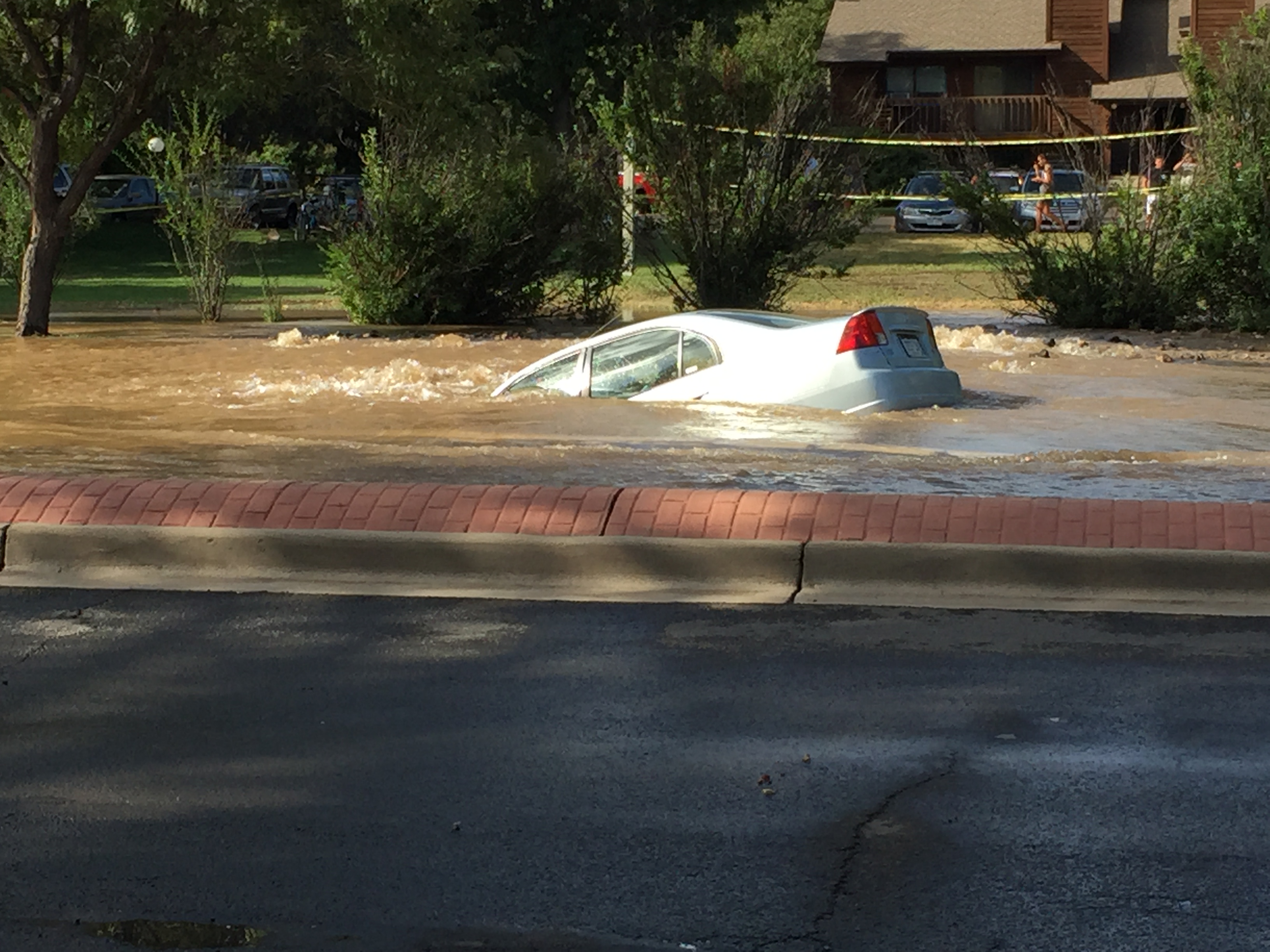 Crews Work To Patch Sinkhole That Left Woman S Car In High Water