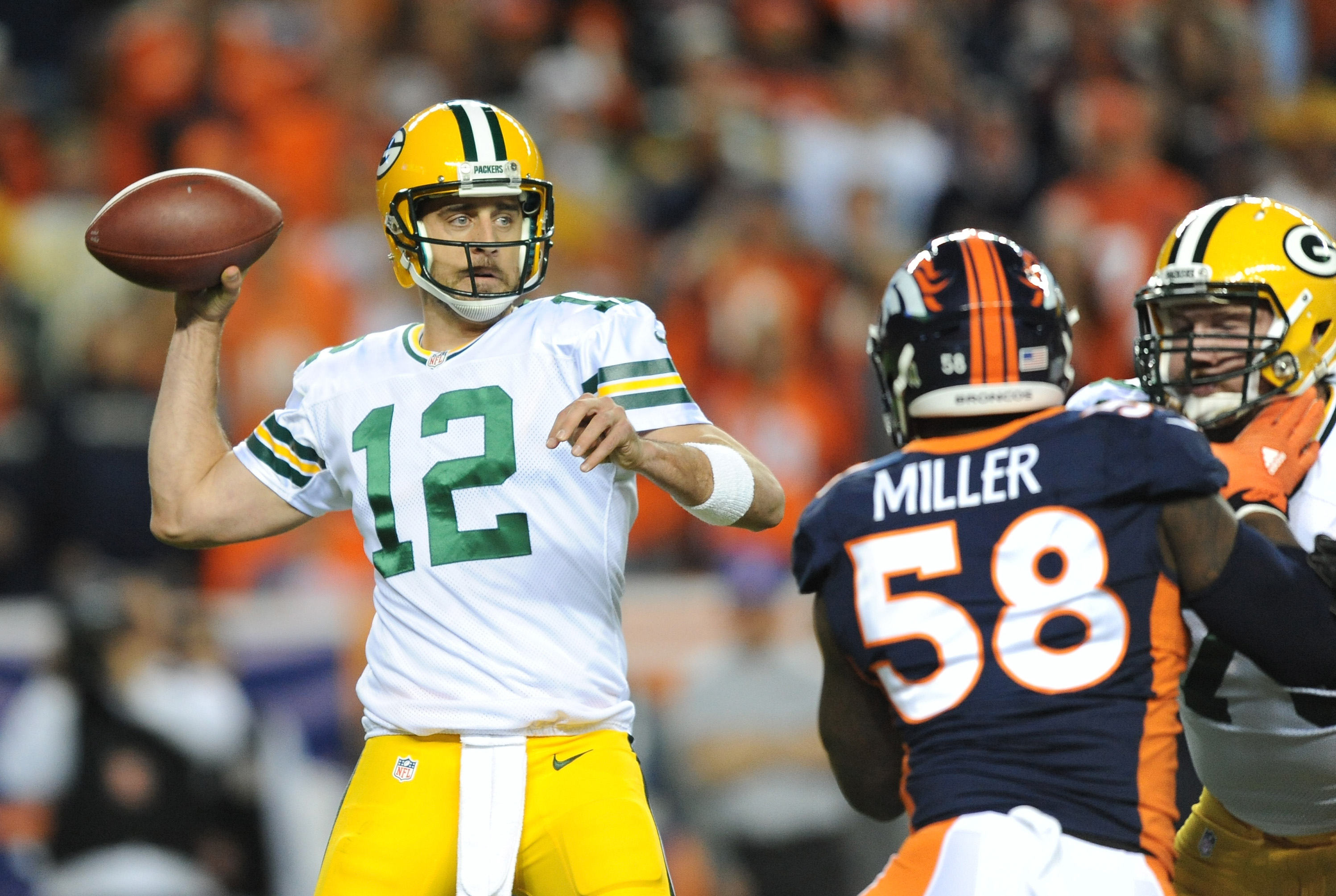 Quarterback Aaron Rodgers #12 of the Green Bay Packers looks to pass against the Von Miller #58 of the Denver Broncos in the first half of the game at Sports Authority Field at Mile High on November 1, 2015 in Denver.