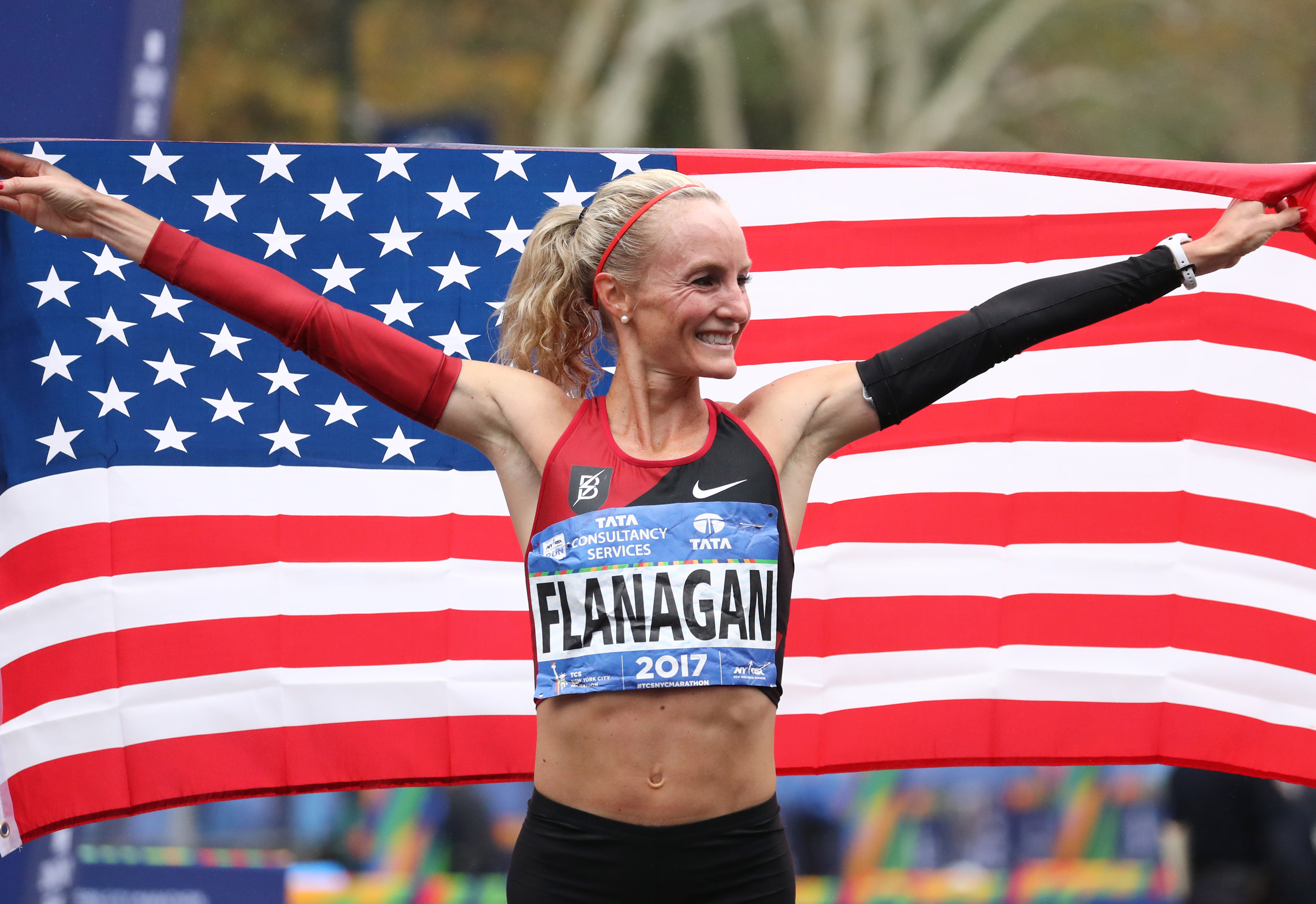Shalane Flanagan of the US reacts after crossing the finish line to win the...