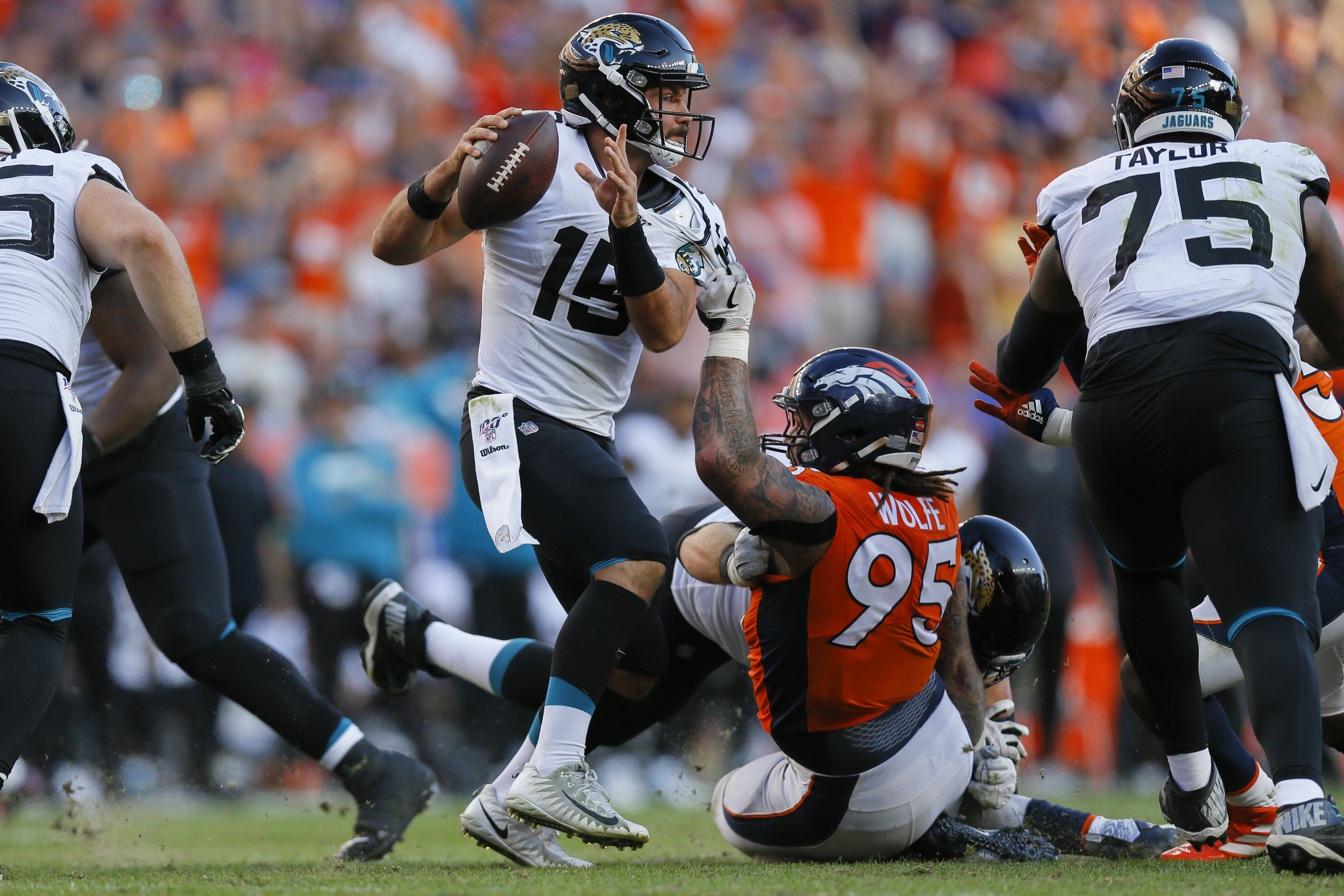 Quarterback Gardner Minshew of the Jacksonville Jaguars tries to escape while being held by defensive end Derek Wolfe of the Denver Broncos during the fourth quarter on Sunday.