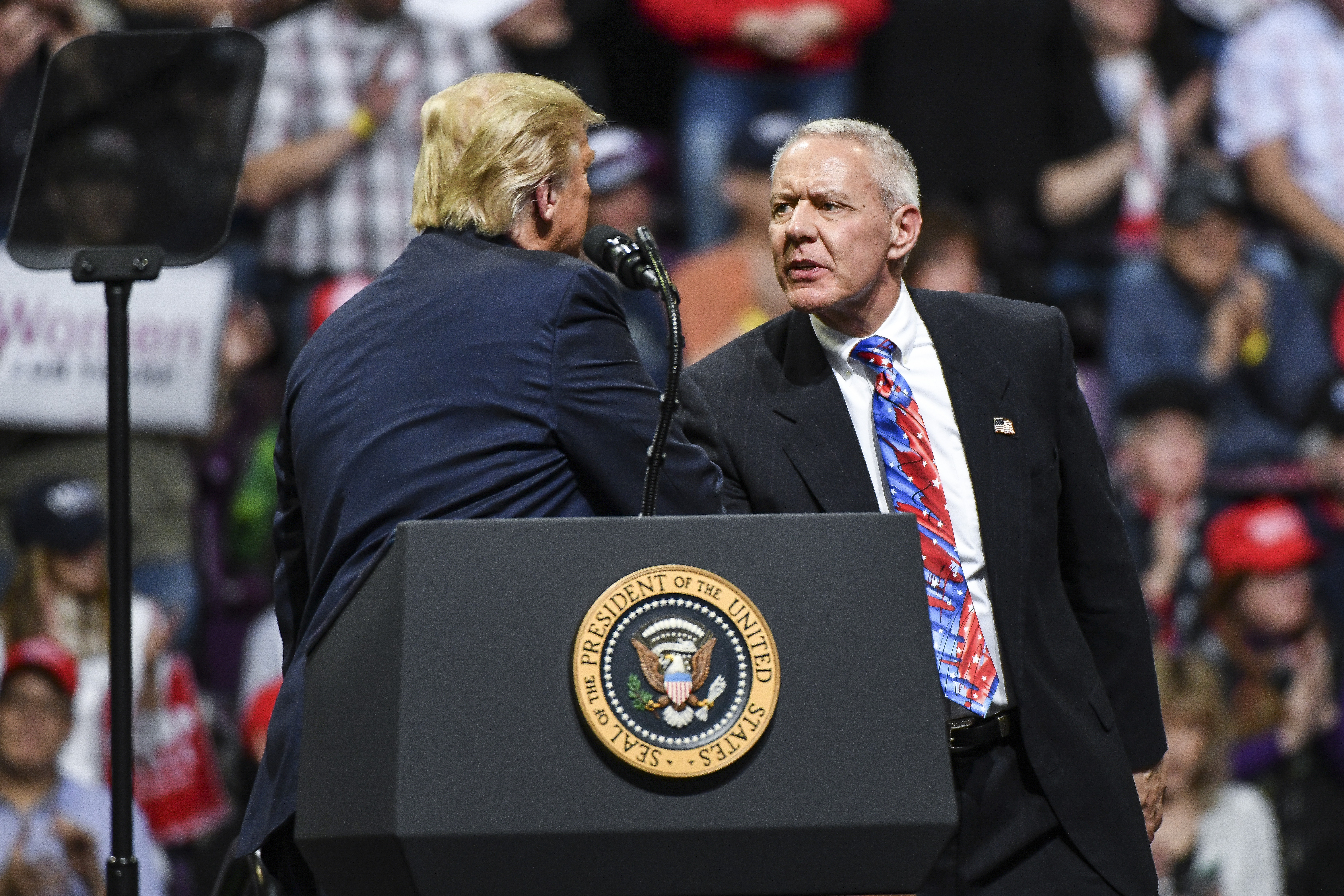 Rep. Ken Buck shakes hands with President Donald Trump on stage during a Keep America Great rally on Feb. 20, 2020 in Colorado Springs.