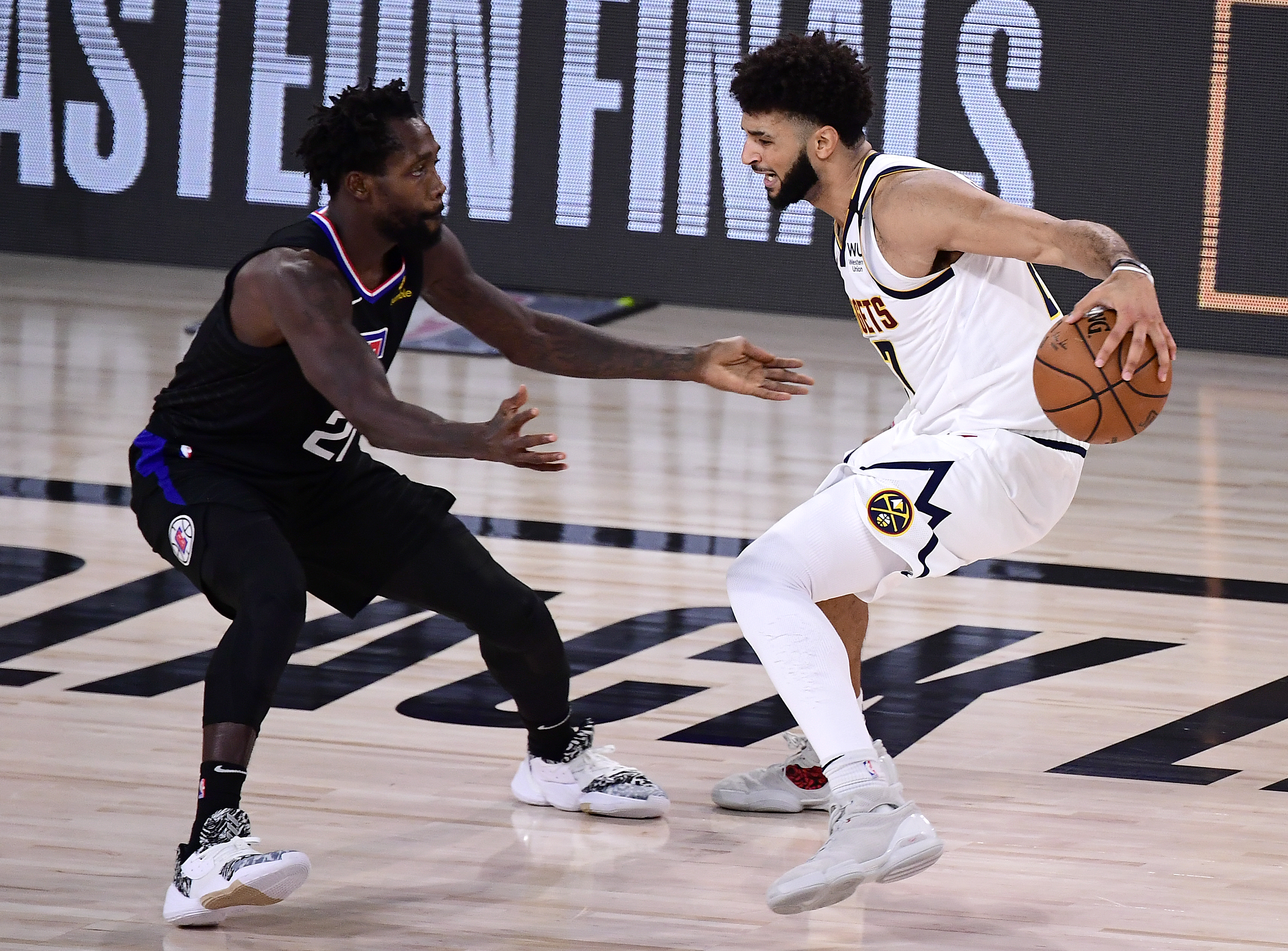 Jamal Murray of the Denver Nuggets drives the ball against Patrick Beverley of the LA Clippers in Game 7 of the Western Conference Second Round during the 2020 NBA Playoffs at AdventHealth Arena at the ESPN Wide World Of Sports Complex on Sept. 15, 2020.