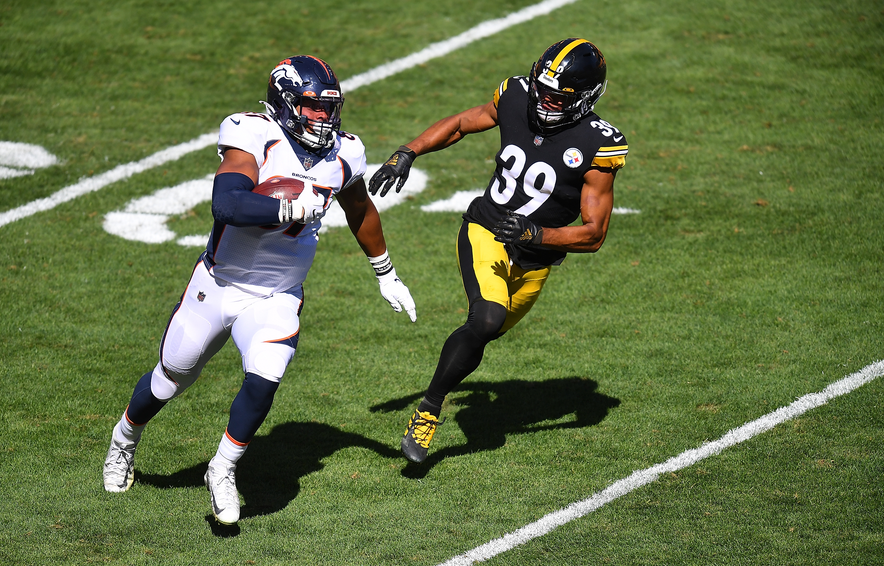 Noah Fant of the Denver Broncos carries the ball in front of Minkah Fitzpatrick of the Pittsburgh Steelers at Heinz Field on Sept. 20, 2020.