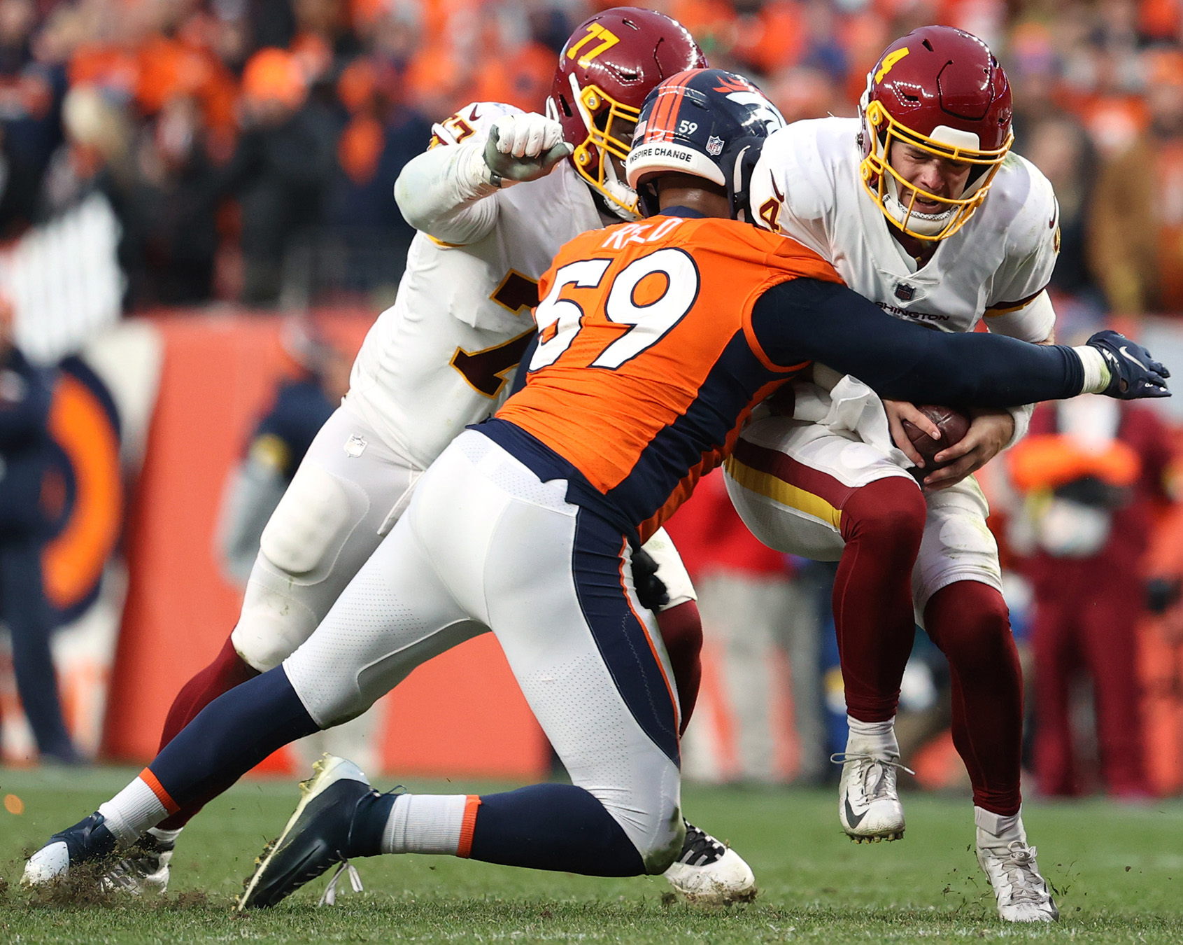 Malik Reed of the Denver Broncos sacks Taylor Heinicke of the Washington Football Team in the fourth quarter at Empower Field At Mile High on Oct. 31, 2021.