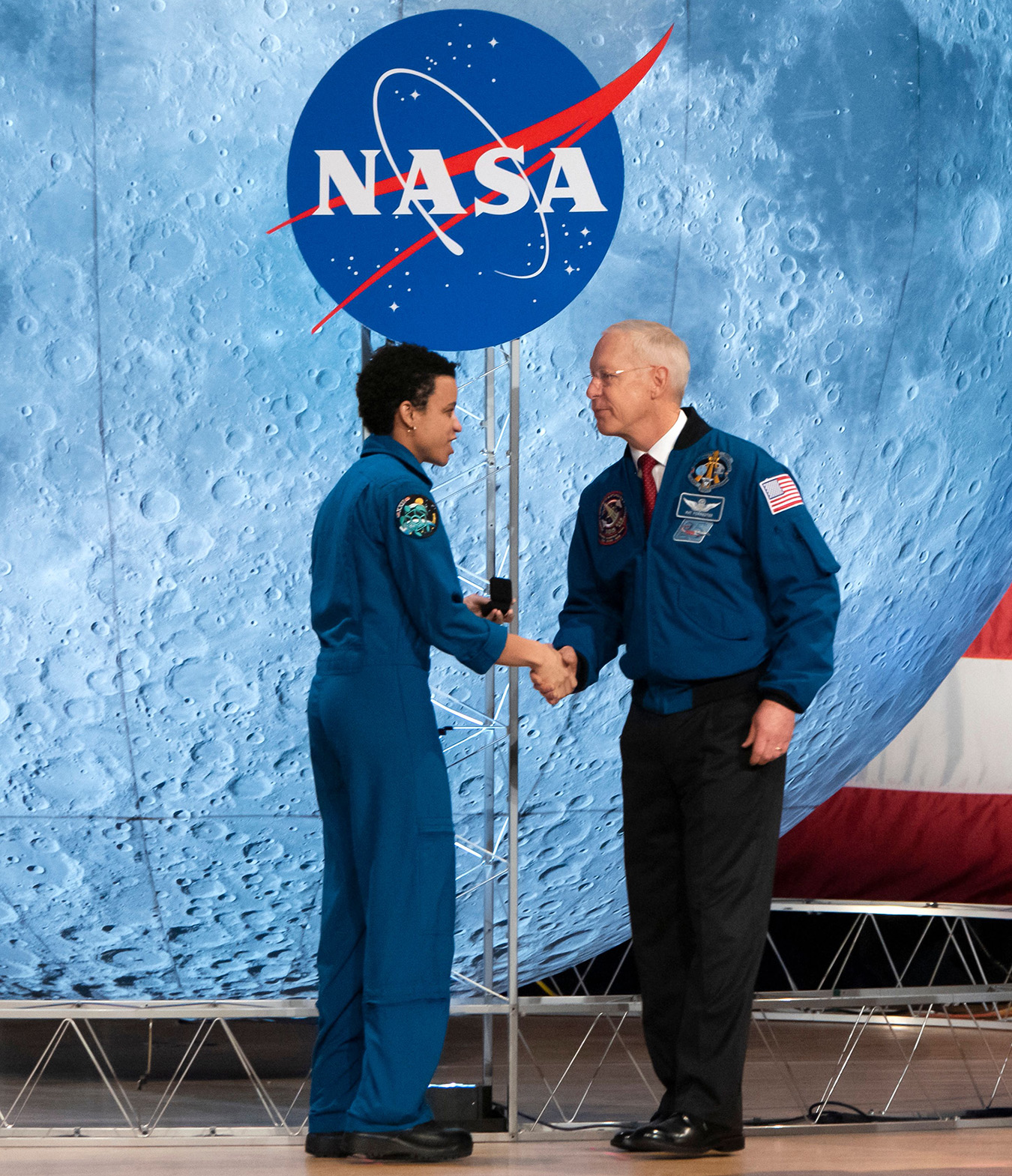 NASA astronaut Jessica Watkins shakes hands with former astronaut Patrick G. Forrester during the astronaut graduation ceremony at Johnson Space Center in Houston Texas, on January 10, 2020. 
