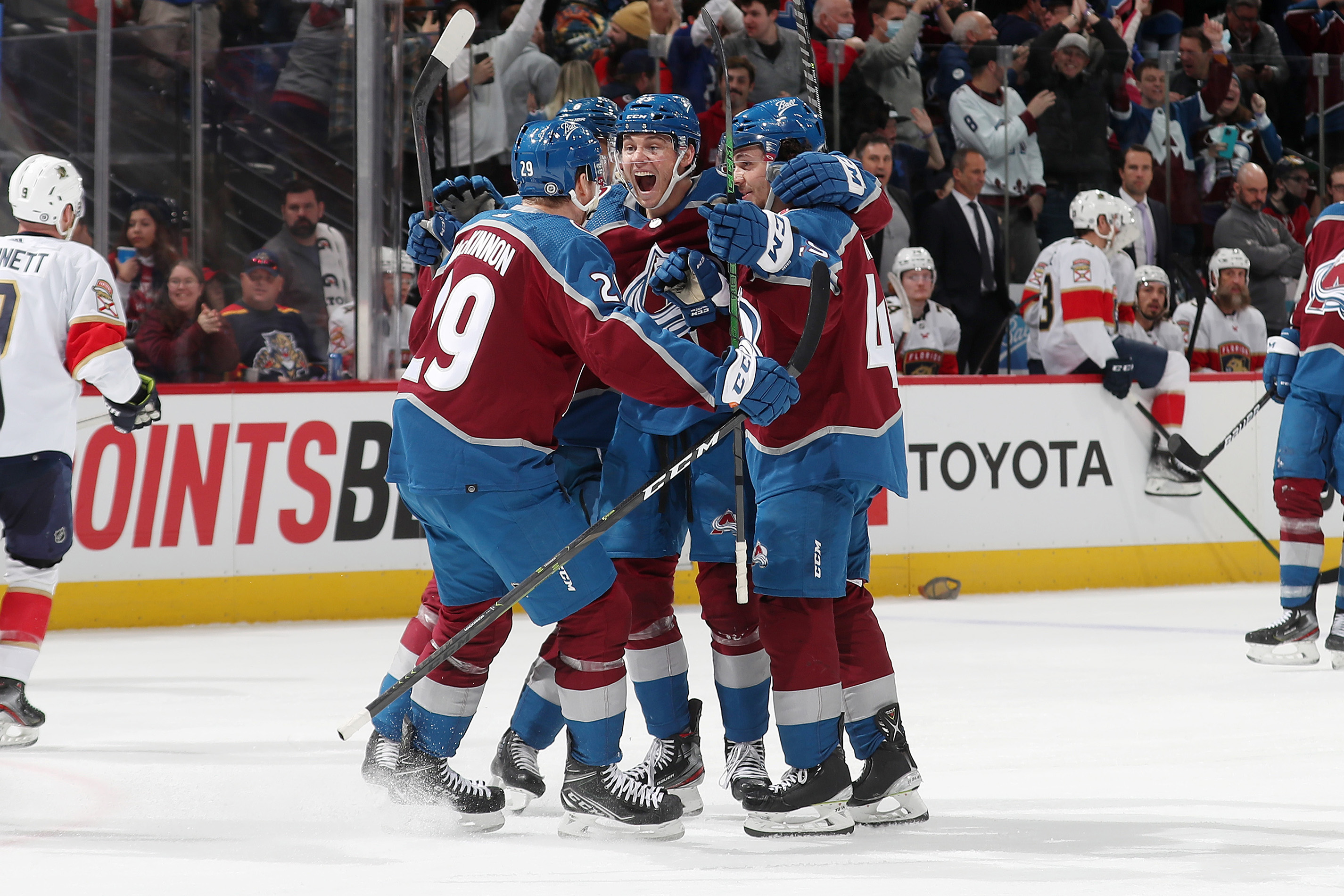 Andre Burakovsky of the Colorado Avalanche celebrates this third goal of the game against the Florida Panthers with teammates Nathan MacKinnon #29, Erik Johnson #6 and Samuel Girard #49 at Ball Arena on December 12, 2021.