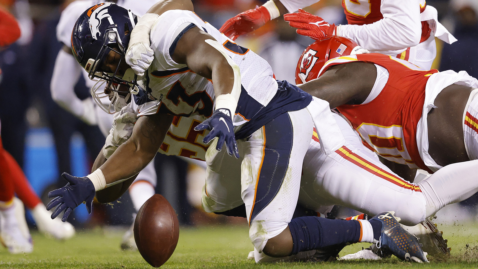Javonte Williams of the Denver Broncos fumbles and recovers the ball against the Kansas City Chiefs during the second half at Arrowhead Stadium on Dec. 5, 2021.