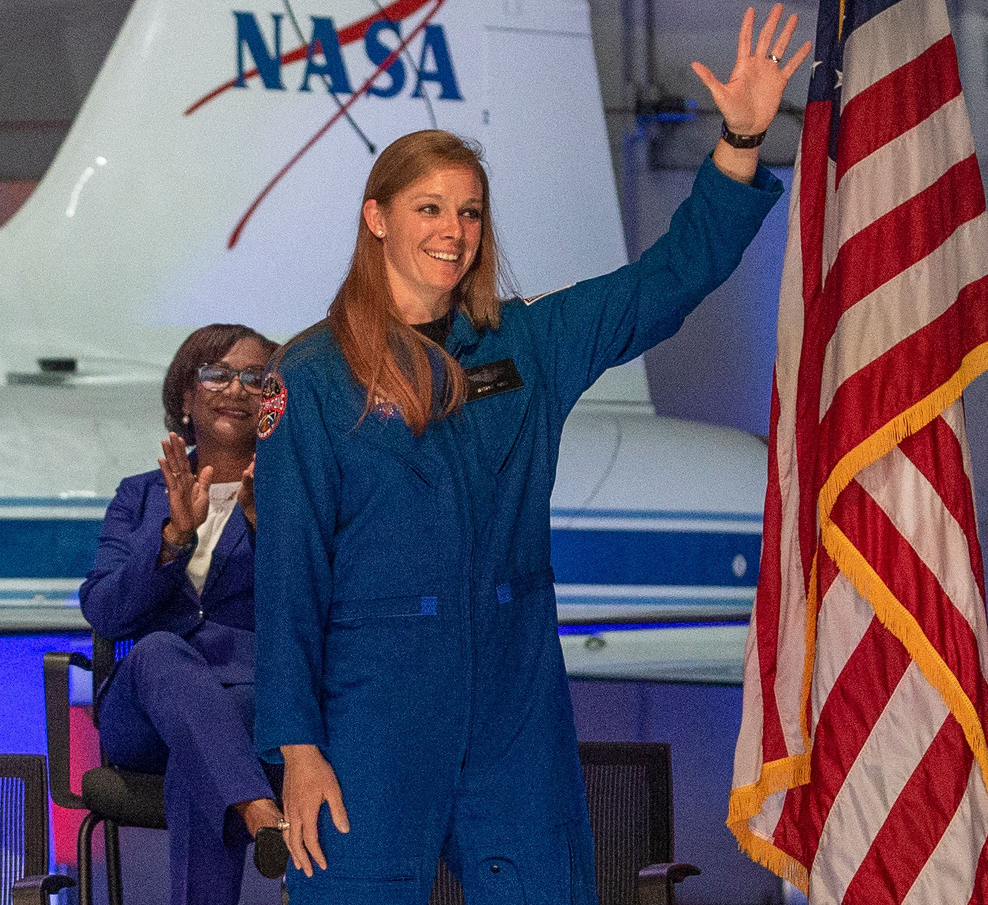 Nichole Ayers, 32, major, US Air Force, waves as she is introduced at the NASA's 2021 Astronaut Candidate announcement event on December 6, 2021 at Ellington Field in Houston, Texas. - NASA announced its 10 latest trainee astronauts, who include a firefighter turned Harvard professor, a former member of the national cycle team, and a pilot who led the first-ever all-woman F-22 formation in combat. The 2021 class was whittled down from a field of more than 12,000 applicants and will now report for duty in January at the Johnson Space Center in Texas, where they will undergo two years of training.
