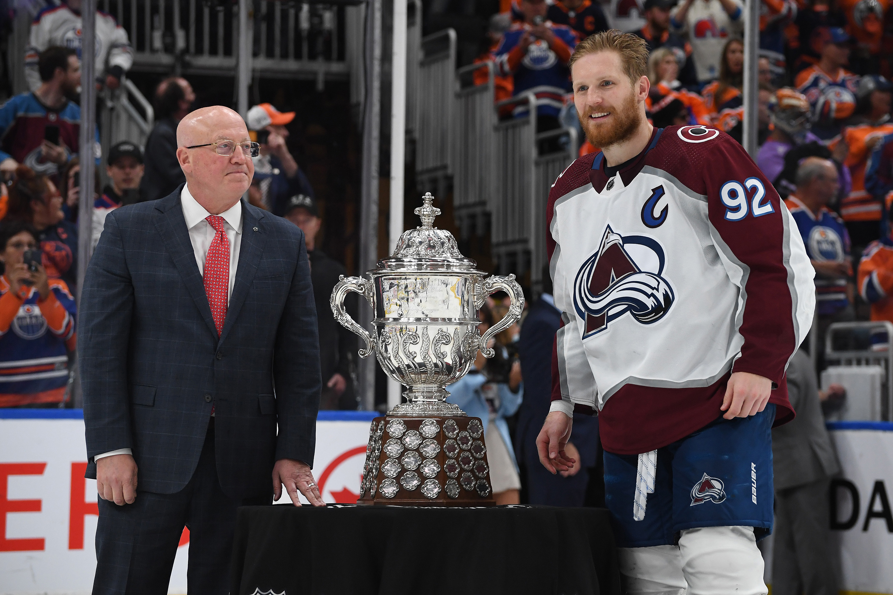 Gabriel Landeskog #92 of the Colorado Avalanche poses for a photo with Deputy Commissioner Bill Daly before the presentation of the Clarence S. Campbell Bowl after defeating the Edmonton Oilers 6-5 in overtime in Game Four of the Western Conference Final of the 2022 Stanley Cup Playoffs at Rogers Place on June 6, 2022 in Edmonton, Alberta.
